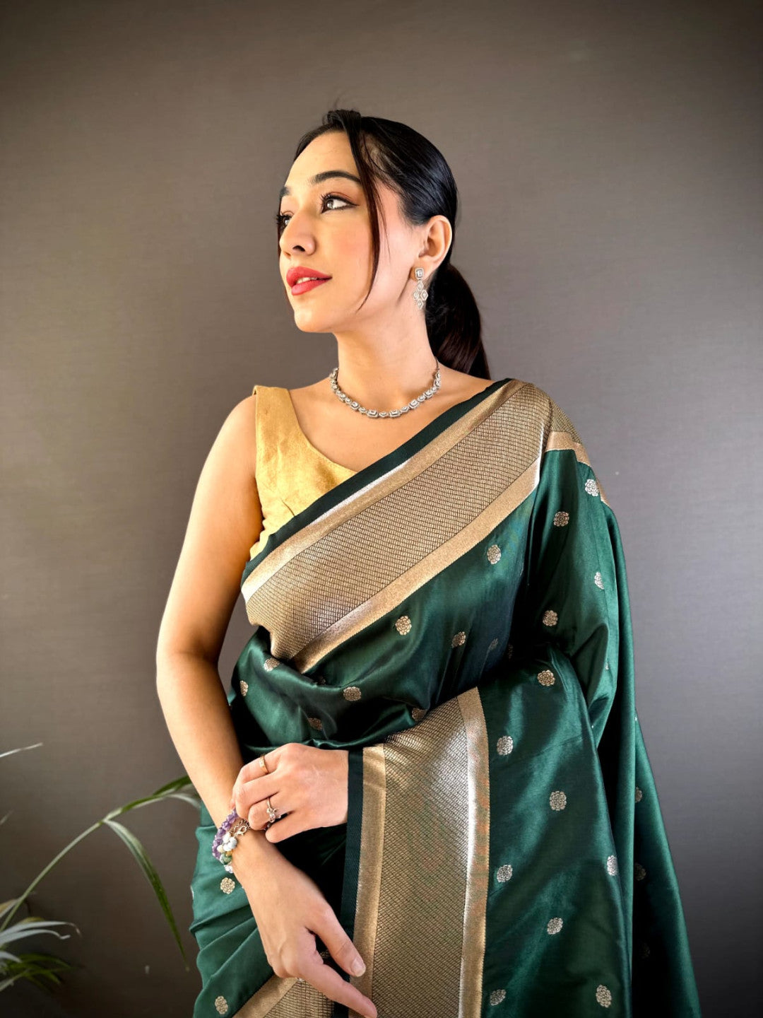 Dark green traditional paithani silk saree with zari weaving work