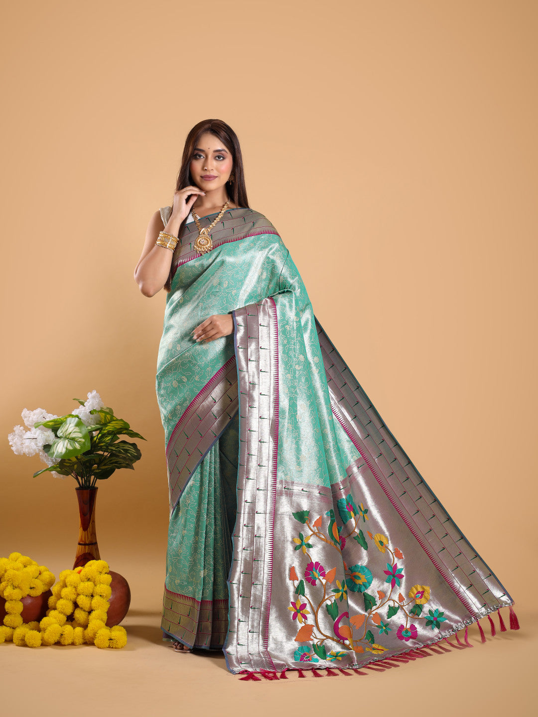 Sea green color tissue silk saree with woven design