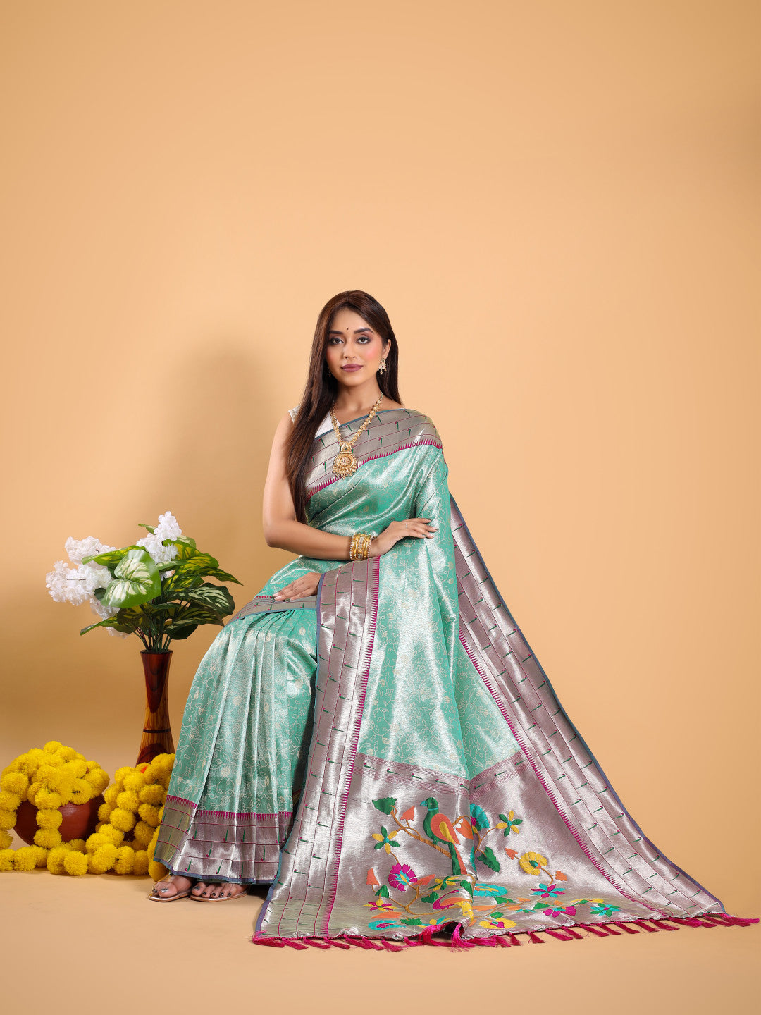 Sea green color tissue silk saree with woven design
