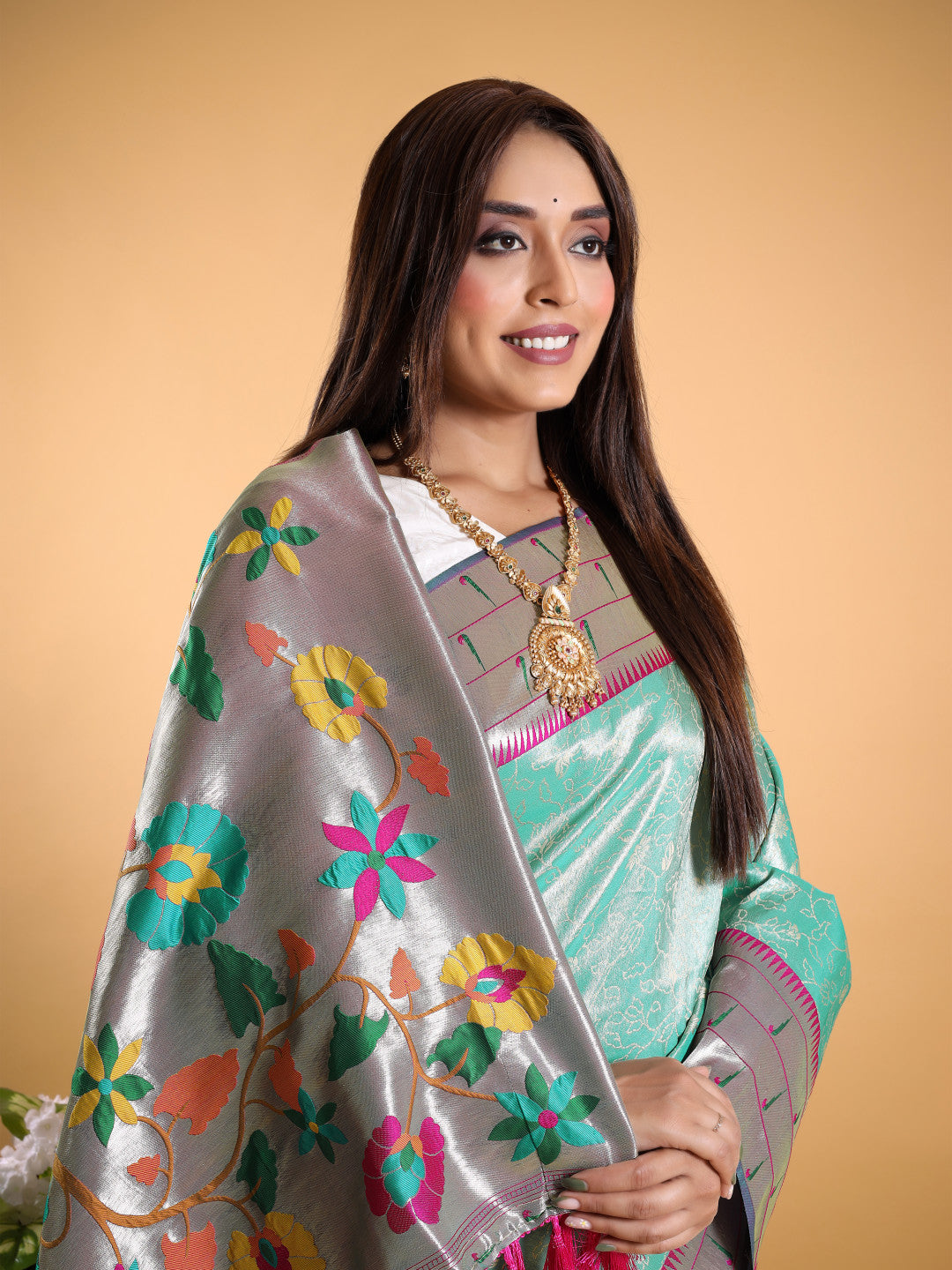 Sea green color tissue silk saree with woven design