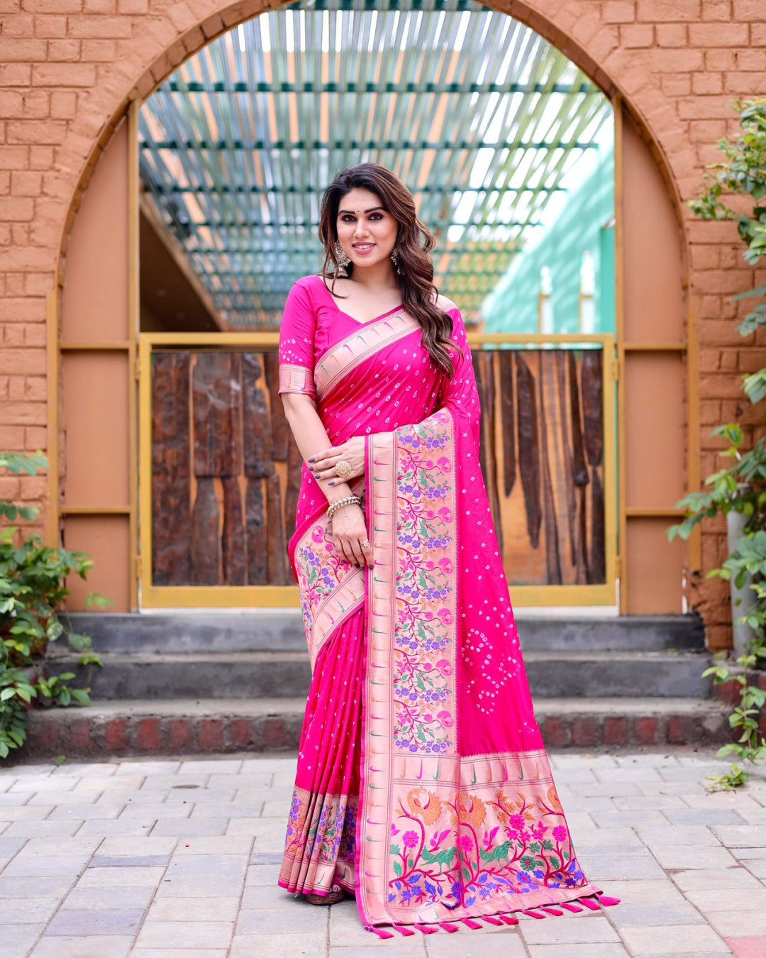 Rani pink color bandhej silk saree with zari weaving work