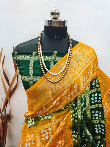 Dark green and yellow color hand bandhej silk saree with zari weaving work