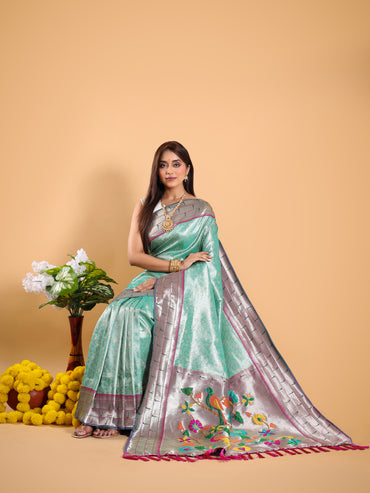 Sea green color tissue silk saree with woven design